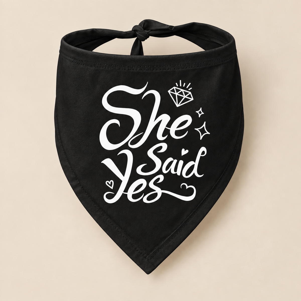 Black dog bandana with black She Said Yes lettering, diamond and heart details on a beige background