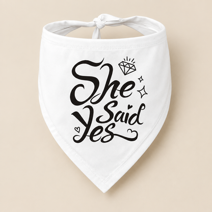 White dog bandana with black She Said Yes lettering, diamond and heart details on a beige background